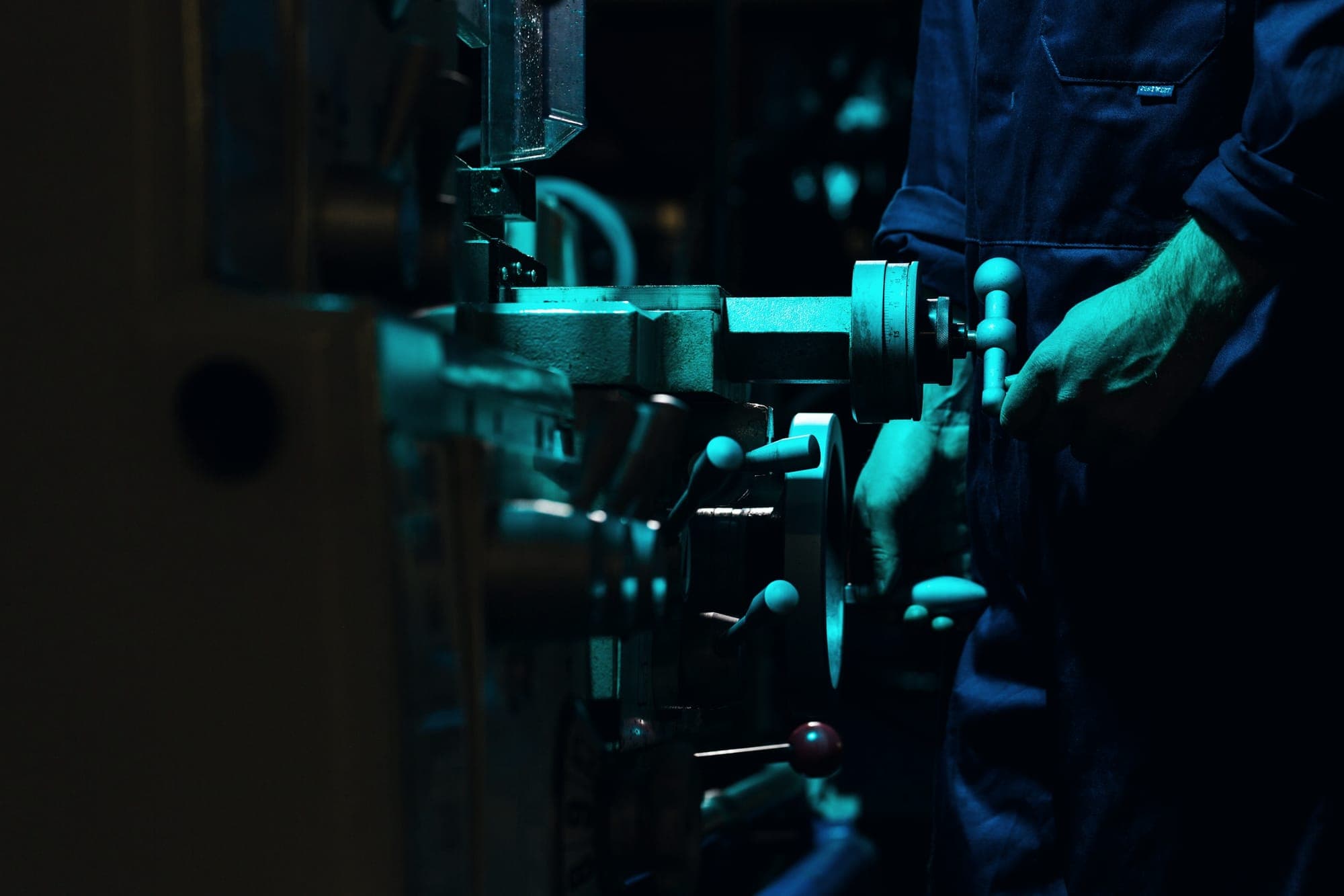 Engineer adjusting machinery in a workshop