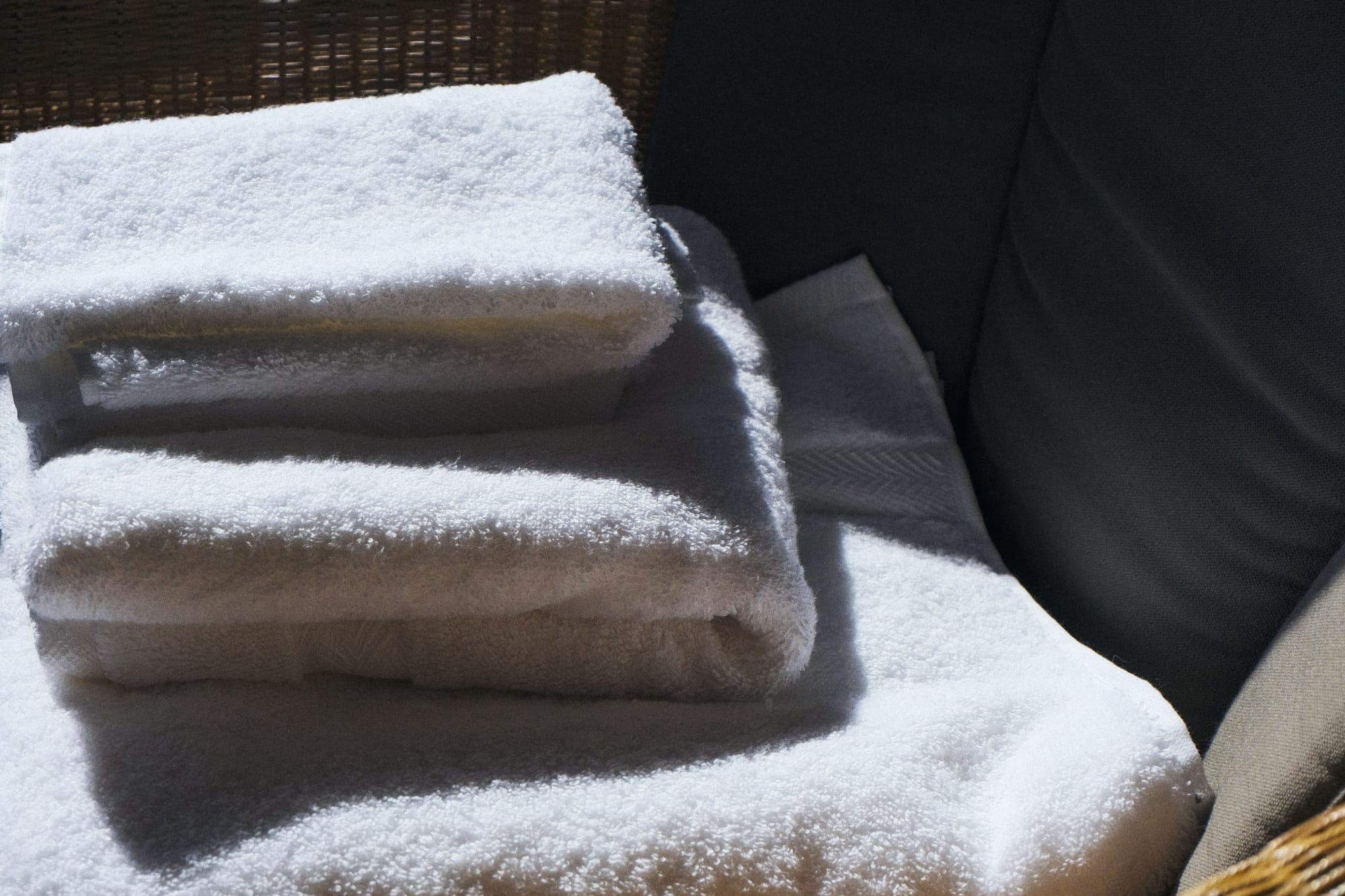 Stack of freshly laundered white towels in soft morning light